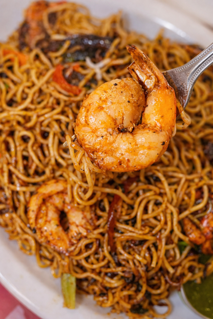 Wok tossed noodles with vegetables and savory sauce at INDYA Restaurant.